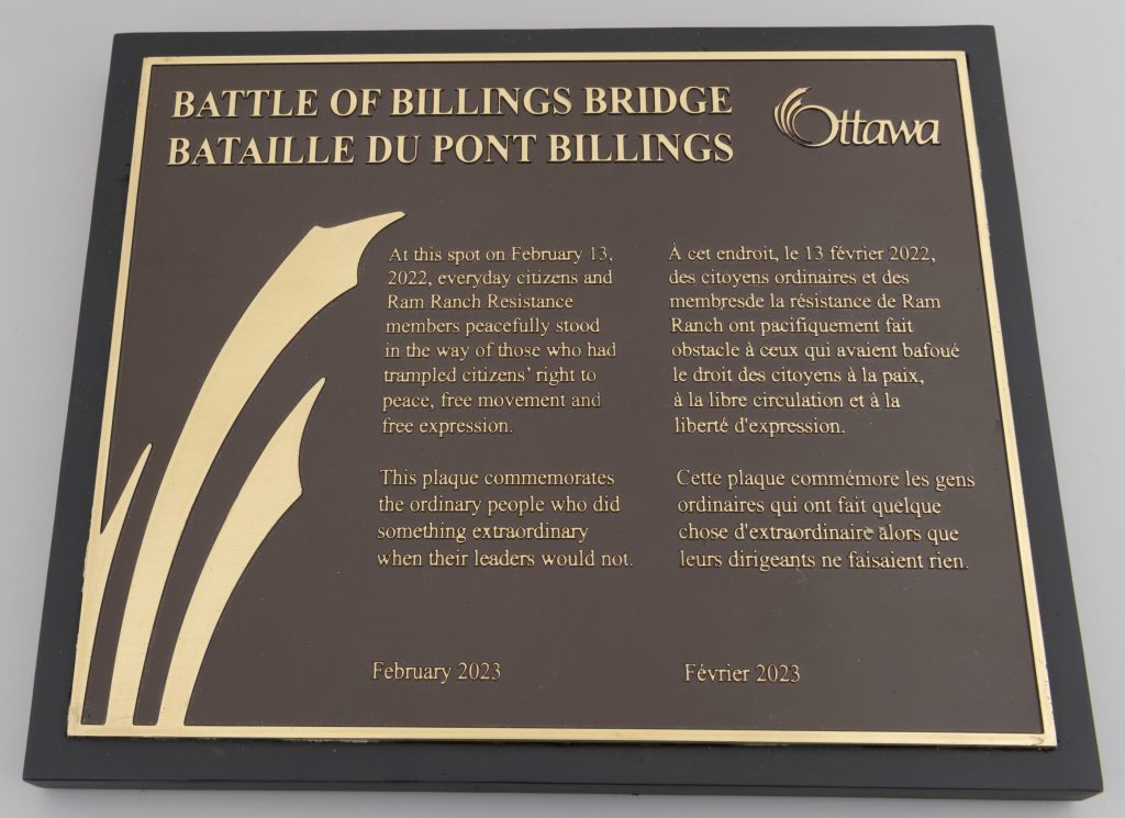 Une plaque en laiton ressemblant à une plaque officielle du patrimoine, intitulée « La bataille du pont Billings ».