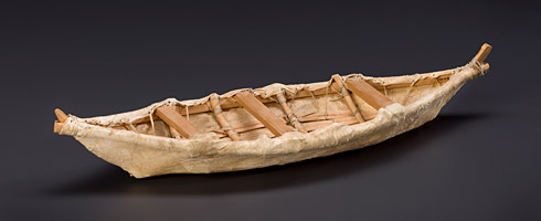 A 3D model of a wooden boat on a black surface.