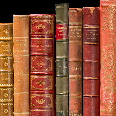 A row of old books on a black background in Ottawa.