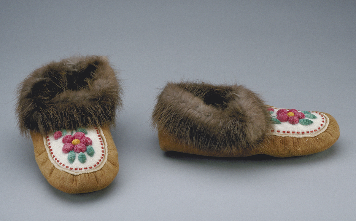 Une paire de mocassins avec fourrure et fleurs exposée au Musée canadien de l'histoire à Ottawa.