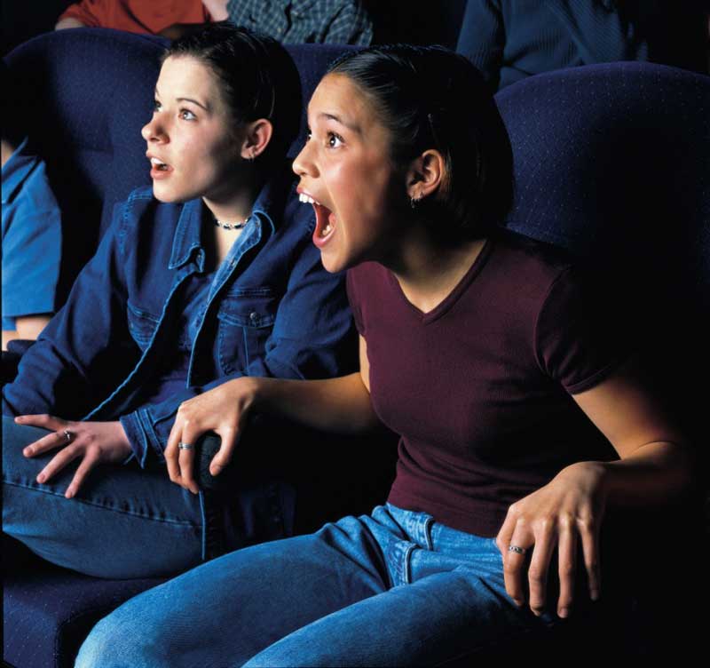 A group of people sitting in a theater at the Canadian Museum of History, in Ottawa, watching a movie.